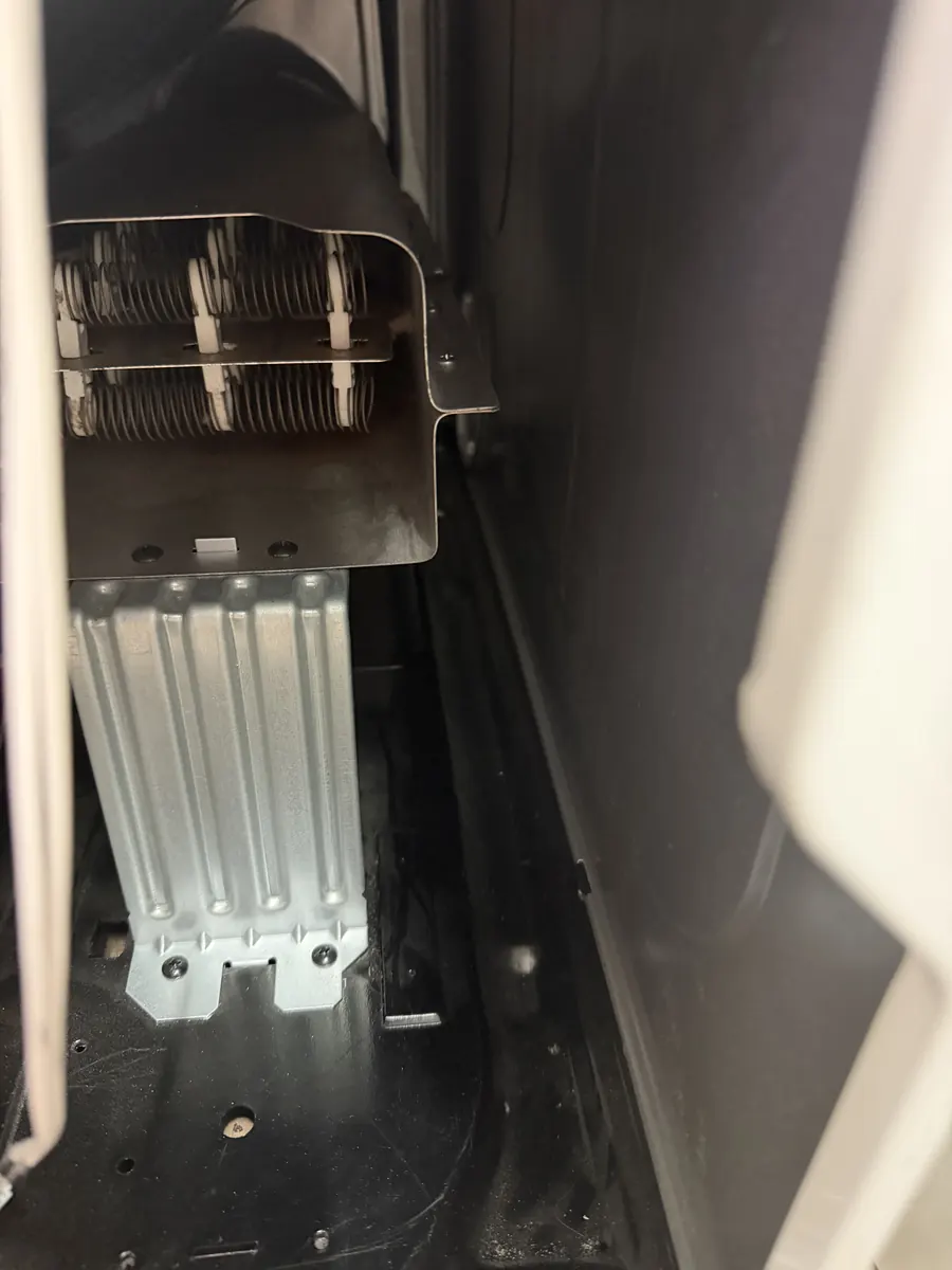 Electric dryer cabinet after accumulated lint and debris were removed
