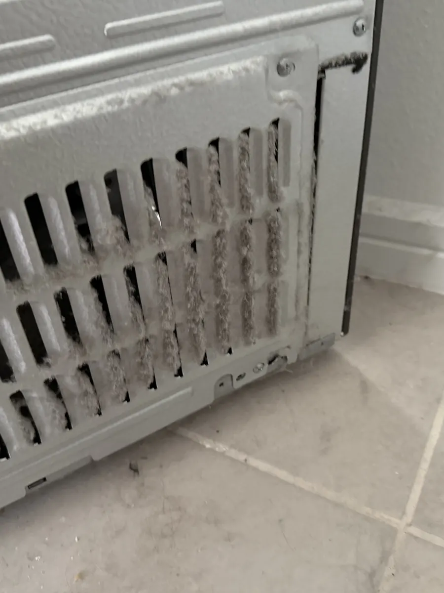 Heavy frost around a freezer evaporator cover during refrigerator inspection